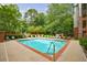 Refreshing community pool surrounded by lush greenery and lounge chairs at 50 Biscayne Nw Dr # 4110, Atlanta, GA 30309