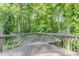 Cozy deck featuring a relaxing hammock and views of the surrounding greenery at 5930 Bridle Dr, Cumming, GA 30028