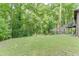 Expansive backyard with mature trees and lush greenery, perfect for outdoor activities at 5930 Bridle Dr, Cumming, GA 30028