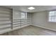 Finished basement with vinyl flooring and custom shelving at 5930 Bridle Dr, Cumming, GA 30028