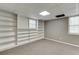 Spacious basement area features built-in shelving and carpeted floor at 5930 Bridle Dr, Cumming, GA 30028