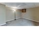 Cozy basement with plush carpeting, a built-in cabinet, and warm lighting at 5930 Bridle Dr, Cumming, GA 30028