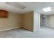 Versatile basement space with neutral carpeting, overhead lighting, and multiple entryways at 5930 Bridle Dr, Cumming, GA 30028