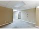 Basement features neutral walls, carpeting, and access to additional rooms and storage at 5930 Bridle Dr, Cumming, GA 30028