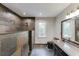 Bathroom featuring modern tile in the shower and floors, a large mirror, and stone countertops at 5930 Bridle Dr, Cumming, GA 30028