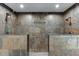 Luxurious bathroom featuring a spacious, tiled walk-in shower with dual shower heads at 5930 Bridle Dr, Cumming, GA 30028