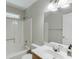 This bathroom features a shower, sink, and a window for natural light at 5930 Bridle Dr, Cumming, GA 30028