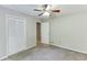 This spacious bedroom features a ceiling fan, plush carpet, and closet space at 5930 Bridle Dr, Cumming, GA 30028