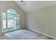 This bedroom features a large arched window and plush carpet at 5930 Bridle Dr, Cumming, GA 30028