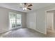 This is a carpeted bedroom with a double window, ceiling fan, and a closet with paneled doors at 5930 Bridle Dr, Cumming, GA 30028