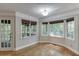 Bright breakfast nook with hardwood floors and bay window offering abundant natural light and wooded views at 5930 Bridle Dr, Cumming, GA 30028
