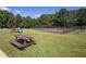 Community amenities with picnic table, playset, and fenced tennis courts amid a grassy field at 5930 Bridle Dr, Cumming, GA 30028