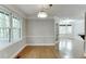 Bright dining area with hardwood floors, windows, and chandelier at 5930 Bridle Dr, Cumming, GA 30028