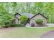 Charming single-story home featuring mature trees and meticulously maintained landscaping at 5930 Bridle Dr, Cumming, GA 30028