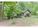 Beautifully landscaped front yard featuring mature trees, manicured shrubbery, and a well-maintained lawn at 5930 Bridle Dr, Cumming, GA 30028