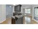 Kitchen with gray cabinets, granite countertops, hardwood flooring open to carpeted living space at 5930 Bridle Dr, Cumming, GA 30028