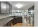 Modern kitchen with dark cabinetry, stainless steel appliances, and wood floors at 5930 Bridle Dr, Cumming, GA 30028