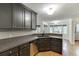 Well-lit kitchen area with gray cabinets, granite countertops, stainless steel appliances, and hardwood flooring at 5930 Bridle Dr, Cumming, GA 30028