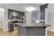 Kitchen with stainless steel appliances, gray cabinets, granite countertops, and hardwood floors at 5930 Bridle Dr, Cumming, GA 30028