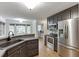 Kitchen features stainless steel appliances, gray cabinets, granite countertops, and hardwood flooring at 5930 Bridle Dr, Cumming, GA 30028