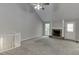 Bright and airy living room featuring plush carpeting, a stone fireplace, and high, vaulted ceilings at 5930 Bridle Dr, Cumming, GA 30028