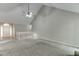 Expansive living room featuring vaulted ceiling, plush carpets, and view of the home's entry and stairs at 5930 Bridle Dr, Cumming, GA 30028