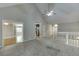 Open living area with hardwood and carpet, vaulted ceiling, and adjacent rooms at 5930 Bridle Dr, Cumming, GA 30028