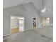 Open living area with plush carpeting, a vaulted ceiling, and views into adjacent dining and kitchen areas at 5930 Bridle Dr, Cumming, GA 30028