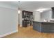 Open living space with kitchen, stainless steel appliances, hardwood floors and gray accent walls at 5930 Bridle Dr, Cumming, GA 30028