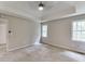 Bright and spacious main bedroom with a tray ceiling, carpet, and plenty of natural light at 5930 Bridle Dr, Cumming, GA 30028
