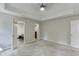 Bright main bedroom with a tray ceiling, carpet, and doors to an ensuite bath and closet at 5930 Bridle Dr, Cumming, GA 30028