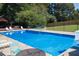 Community pool with chairs, a gazebo, and fencing, offering a refreshing spot for relaxation at 5930 Bridle Dr, Cumming, GA 30028