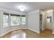 Sunny sitting room with hardwood floors, bay window, and laundry room access at 5930 Bridle Dr, Cumming, GA 30028
