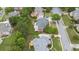 Aerial view of a home with a deck surrounded by green grass and mature trees in a residential neighborhood at 1565 Briergate Dr, Duluth, GA 30097