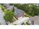 An aerial view of a brick two-story home with a gray roof, attached garage, and well-manicured landscaping at 1565 Briergate Dr, Duluth, GA 30097