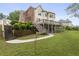 Exterior view of a multi-level home, large back deck, and a stairway leading into the green backyard at 1565 Briergate Dr, Duluth, GA 30097