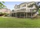 Expansive backyard with a well-maintained lawn, a patio, and a multi-story home at 1565 Briergate Dr, Duluth, GA 30097