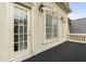 A balcony with a doorway, window, and outdoor sconces at 1565 Briergate Dr, Duluth, GA 30097