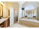 Luxurious bathroom featuring a soaking tub and marble countertops at 1565 Briergate Dr, Duluth, GA 30097
