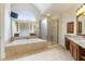 Bright bathroom featuring an enclosed shower, tub, and granite countertops at 1565 Briergate Dr, Duluth, GA 30097