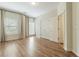 Well-lit bedroom features hardwood floors, neutral walls, and large windows with curtains at 1565 Briergate Dr, Duluth, GA 30097
