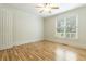 Bright and spacious bedroom has a large window with blinds, hardwood floors, and white trim at 1565 Briergate Dr, Duluth, GA 30097