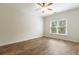 A spacious bedroom with a ceiling fan and bright window at 1565 Briergate Dr, Duluth, GA 30097