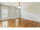 Bright bedroom with gleaming hardwood floors, crown molding, and windows with classic white shutters at 1565 Briergate Dr, Duluth, GA 30097
