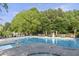 Relaxing community pool with lounge chairs, a lifeguard stand, and lush trees at 1565 Briergate Dr, Duluth, GA 30097