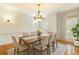 Elegant dining room featuring wainscoting, a stylish chandelier, and a table set for a formal dinner at 1565 Briergate Dr, Duluth, GA 30097
