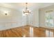 Formal dining room with hardwood floors, wainscoting, and a classic chandelier at 1565 Briergate Dr, Duluth, GA 30097