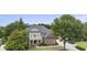 Beautifully landscaped brick home with a covered porch, second-story balcony, and mature trees adding to its charm at 1565 Briergate Dr, Duluth, GA 30097