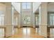 Spacious foyer with soaring ceilings, grand columns, and a glass-paned front door providing ample natural light at 1565 Briergate Dr, Duluth, GA 30097