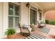 Charming front porch with brick flooring, seating, and decorative planters at 1565 Briergate Dr, Duluth, GA 30097